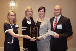 FLY founders Julia and Peter Saulino (at right) accept the 2015 Audesse Award from the Massachusetts Society of Clinical Oncologists.